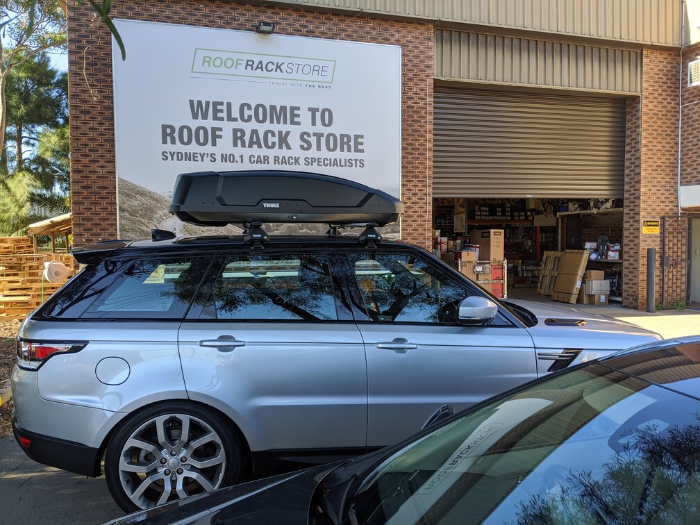 Range Rover Sport With Thule Force M Roof Box On Thule Evo Roof Rack